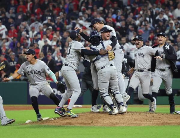 The Yankees celebrate on the mound as they move on to the World Series.