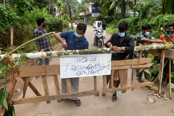 Residents fix a sign reading 