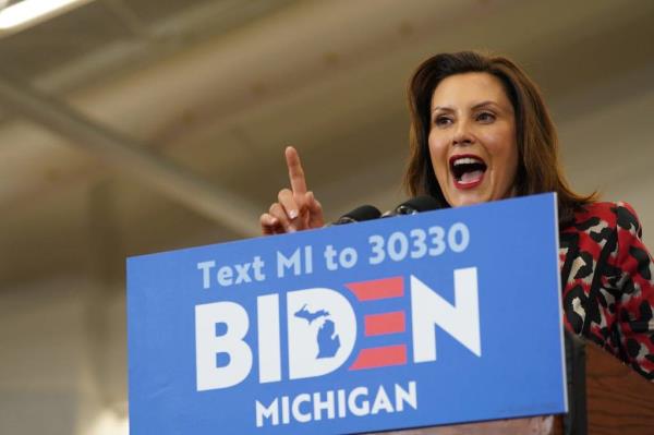Michigan Gov. Gretchen Whitmer speaking into micropho<em></em>nes at a Get Out the Vote event in Detroit
