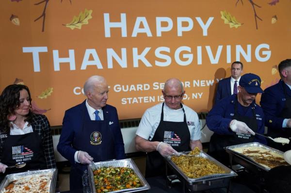 Biden snagged a bun from the assembly line with a mischievous look.
