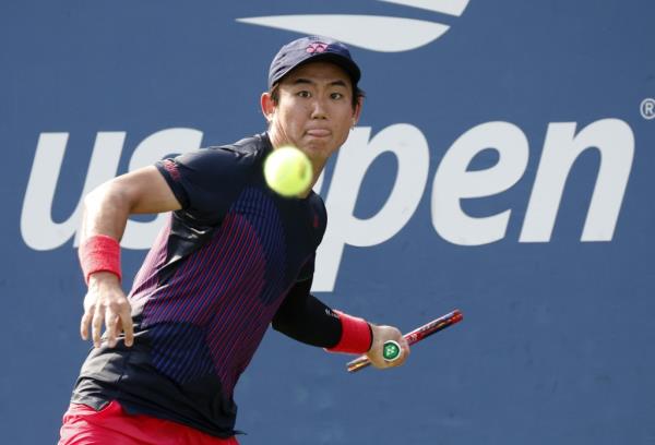 Yoshihito Nishioka of Japan returns a tennis ball to oppo<em></em>nent during the first round of 2024 US Open Tennis Championships