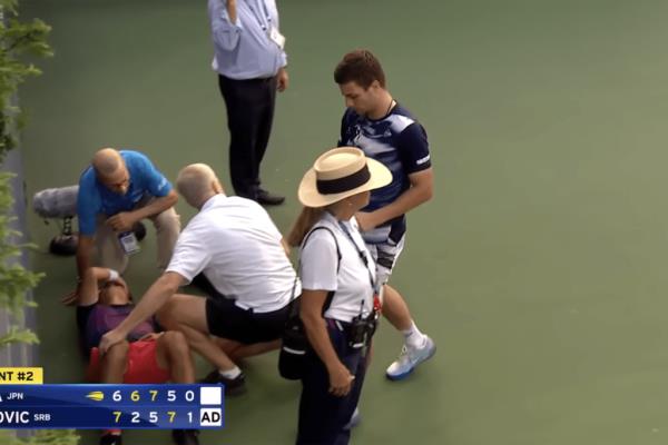 US Open officials come to help Yoshihito Nishioka.