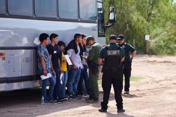 A U.S. Customs and Border Protection officer examines paperwork belo<em></em>nging to Ho<em></em>nduran migrants on Sunday, May 21, 2023 in La Joya, Texas.