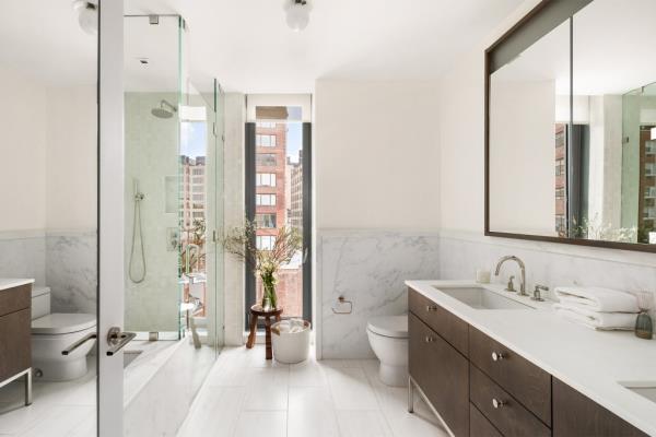The main bathroom offers peek-a-boo city views as well as radiant-heat floors.