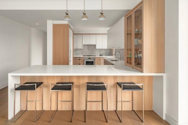 The kitchen is clad with marble backsplashes; appliances include a Bertazzoni cooktop and Leibherr wine fridge.