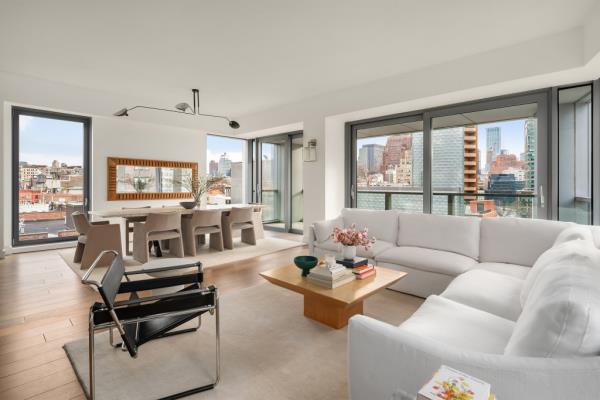 The great room boasts white-oak floors, 10-foot ceilings and terrace access through sliding glass doors.