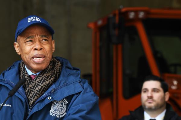 Officials including Eric Adams prepare for winter storm at salt and sand depot. Mayor Adams in blue coat and hat. Photo by Matthew McDermott.