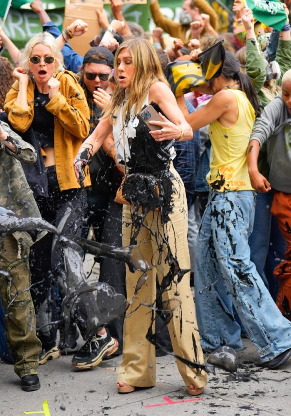Jennifer Aniston gets doused with fake oil