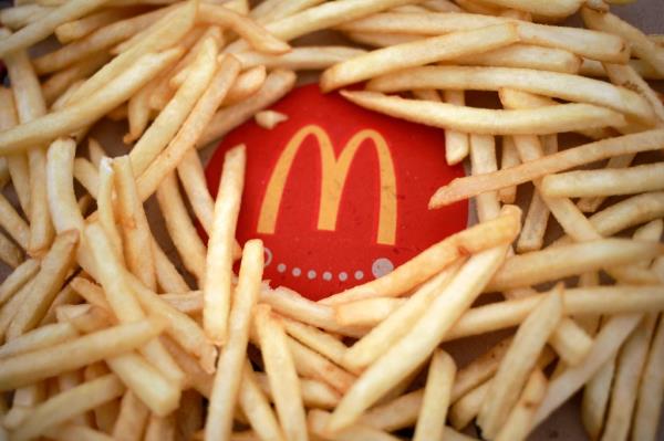 French fries arranged around a McDonald's carton.