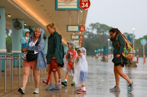 Theme park-goers arrive at Disney World in Orlando, Florida, hours before Hurricane Milton.