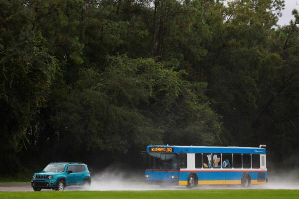A bus drives through the rain, enroute to Disney's Wilderness Lodge ahead of Milton's arrival.