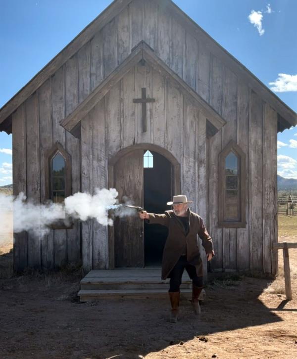 Alec Baldwin firing a gun on set.