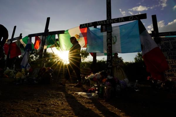 Mourners visit a make-shift memorial to ho<em></em>nor the victims and survivors of the recent human smuggling tragedy, Wednesday, July 6, 2022, in San Antonio.