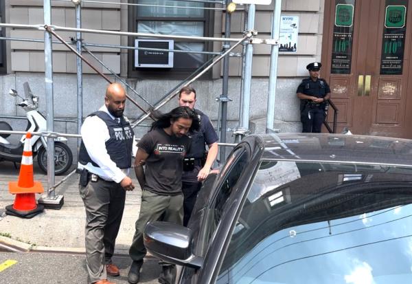 Queens man Judd Sanson getting walked out of the 110th Precinct on June 13, 2024.