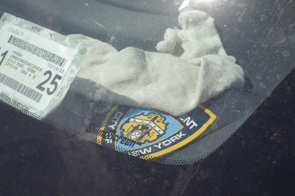 Terror suspect Judd Sanson's car parked at the 110th Precinct with visible evidence of weapo<em></em>nry and police gear inside, taken on June 13, 2024.