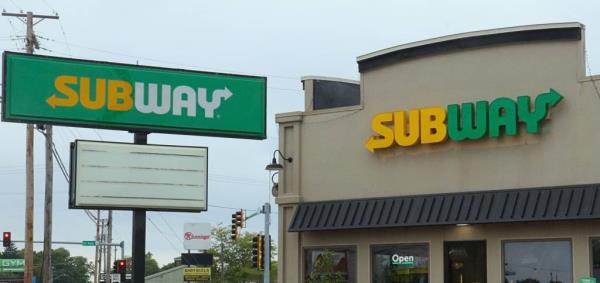 Subway sandwich shop signage promoting a $6.99 footlong deal to attract customers.