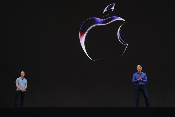 Apple CEO Tim Cook, right, and Apple senior VP of software engineering Craig Federighi