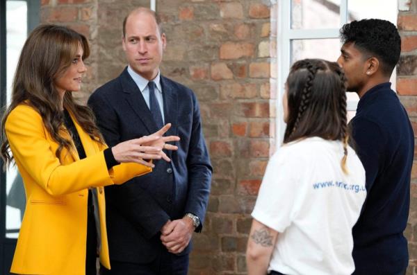 Britain's Prince William, Prince of Wales and Britain's Catherine, Princess of Wales speak to young people.