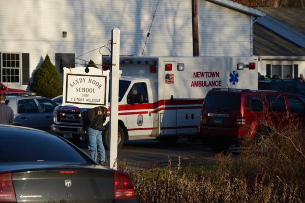 Police and ambulance at at the scene from the aftermath of a school shooting at a the scene of Sandy Hook elementary school on Dec. 14, 2012.