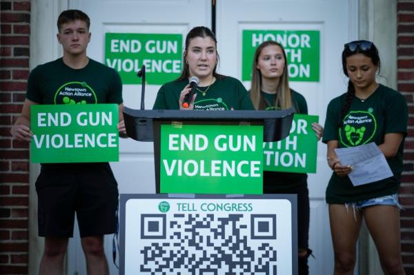 Emma Ehrens, (C), a survivor of the 2012 Sandy Hook Elementary School shooting speaks as she stands with other survivors during a rally against gun violence on Friday, June 7, 2024 in Newtown, Conn.
