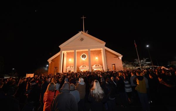People gather for a prayer vigil at St Rose Church following an elementary school shooting in Newtown, Connecticut, Dec. 14, 2012.