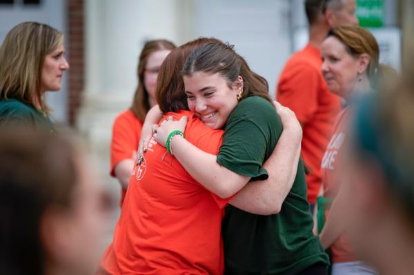 Ehrens hugs a family friend during a rally against gun violence on Friday in Newtown, Conn.