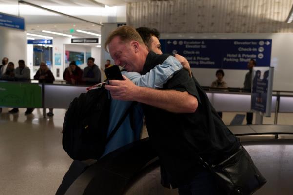 Michael White, a Navy veteran who was jailed in Iran for several years on spying charges, right, hugs Michael's former fellow priso<em></em>ner and Iranian political activist Mahdi Vatankhah.