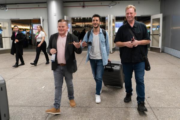 Michael White, Mahdi Vatankhah and Jo<em></em>nathan Franks, a co<em></em>nsultant in the U.S. for families of American hostages and detainees, leave a terminal at the Los Angeles Internatio<em></em>nal Airport.