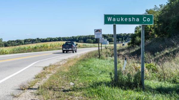 Traffic passing by the Waukesha County sign on State HWY-67 at Evergreen Rd, Wisco<em></em>nsin on Sept. 7, 2024.