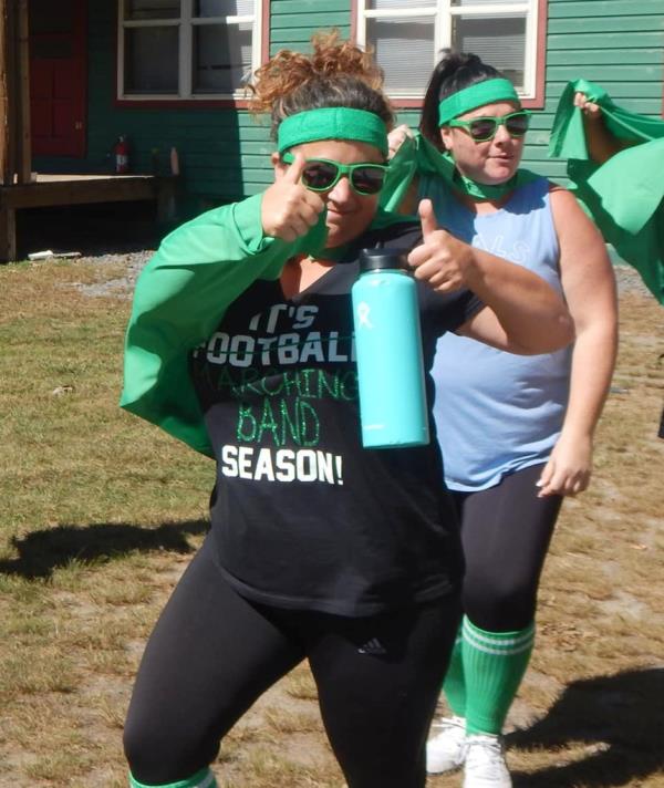 Farmingdale High School Band Gina Pellettiere, 43, is pictured hyping up the marching band.