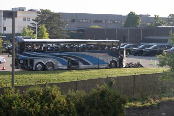 The mangled remains of the bus are seen.