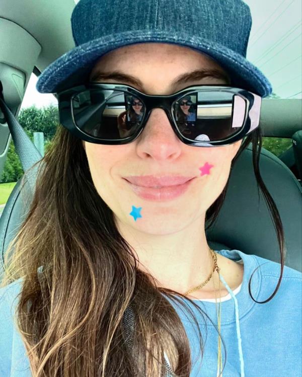Anne Hathaway posing for a makeup-free selfie with pimple patches on her face
