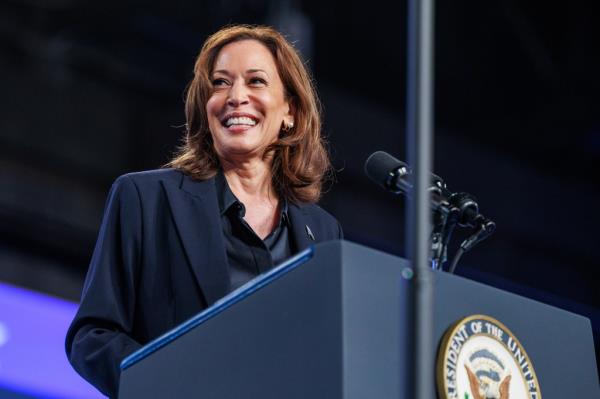 Vice President Kamala Harris speaking at a rally in Flint, Michigan, standing at a podium on October 4, 2024.