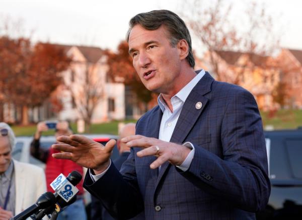 Virginia Gov. Glenn Youngkin gestures as he talks with reporters after greeting voters at a polling station during Election Day,  Tuesday Nov. 7, 2023