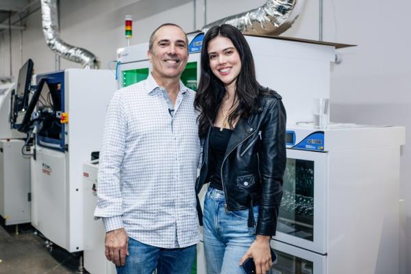 Randy Howie and Lydia Moynihan standing in front of a machine at Standard Bots in Glen Cove, Long Island, photographed by Emmy Park for NY Post, September 18, 2024.