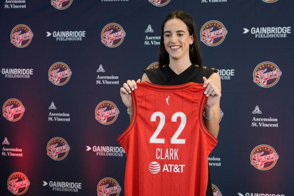 Indiana Fever's Caitlin Clark holds her jersey following a WNBA basketball news conference, Wednesday, April 17, 2024
