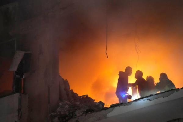 Firefighters try to extinguish the fire inside an apartment following a massive explosion in the southern suburb of Beirut, Lebanon, Tuesday, Jan. 2, 2024.