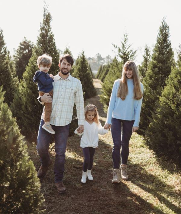 Leo Lukenas, his wife and their kids walking through what looks like a Christmas Tree farm.
