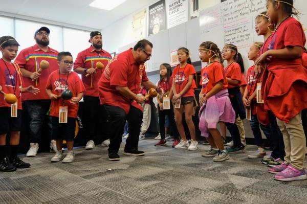 California Assemblymember James C. Ramos dances with fourth-grade students and teachers from Inland Empire schools celebrating the anticipated passage of a bill at the California State University- San Bernardino on Sept. 23, 2024.