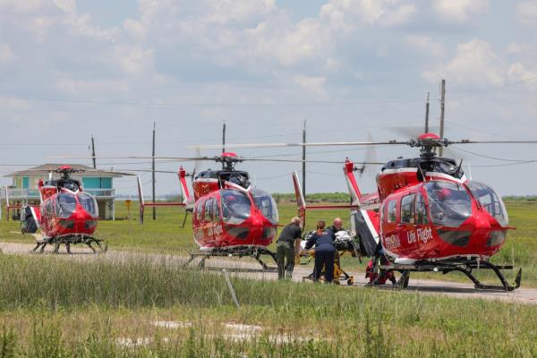 First respo<em></em>nders load a person on a stretcher into a helicopter. 
