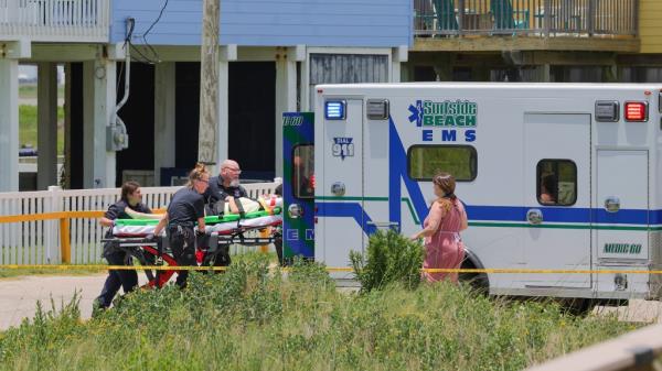 First respo<em></em>nders load a teen on a stretcher into an ambulance. 