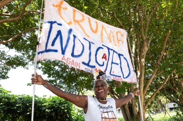 A Georgia woman shows her support for Trumps' indictment outside Fulton County Jail on Wednesday.