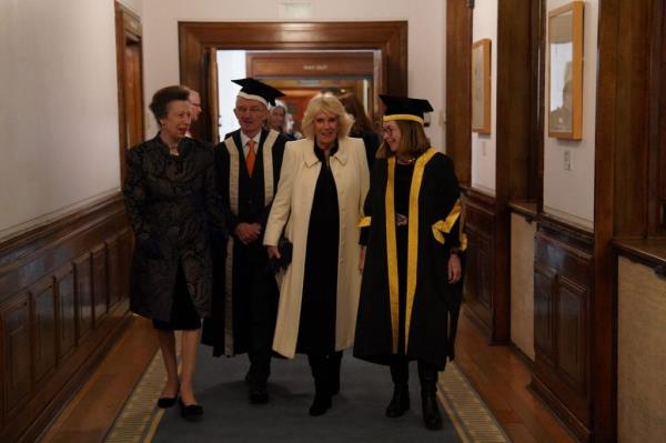 Queen Camilla and Princess Anne walking in graduation attire at the University of London's Foundation Day, wher<em></em>e Queen Camilla is awarded an Ho<em></em>norary Doctorate of Literature.