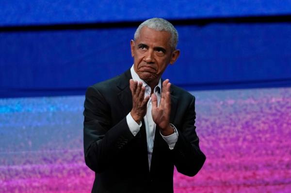 Former President Barack Obama applauds an audience last month.