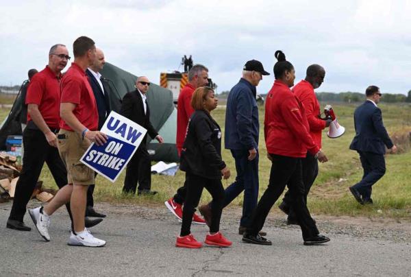 Joe Biden with striking members of the United Auto Workers (UAW) on the picket line outside the GM's Willow Run Distribution Center, in Bellville, Wayne County, Michigan.