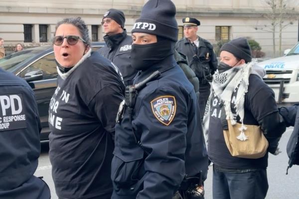 A group of people in police uniforms arresting demo<em></em>nstrators outside the Met Museum during a Joe Biden fundraiser event on Wednesday Feb 7, 2024.
