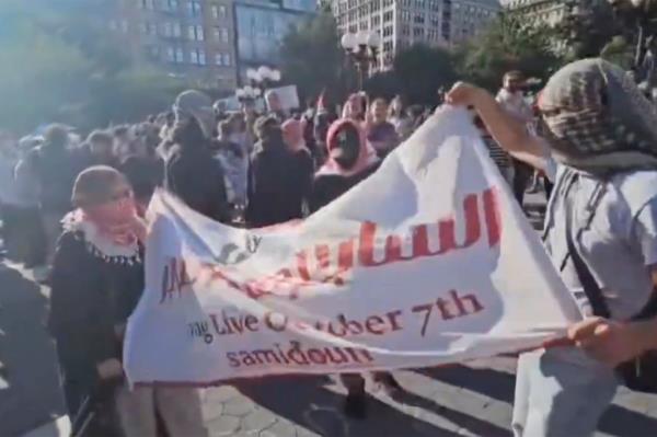 Anti-Israel protesters marching with a flag that says 