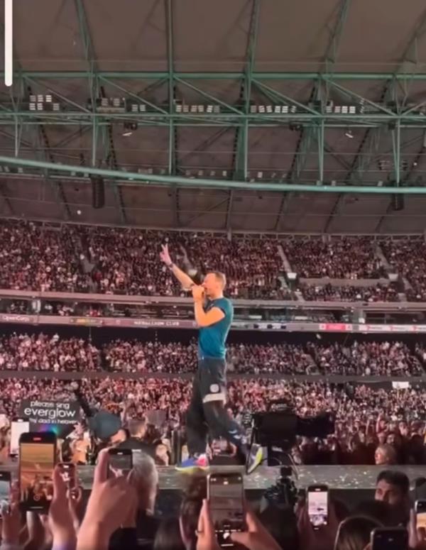 Chris Martin stumbling backwards through an opened trap door during a co<em></em>ncert in Melbourne