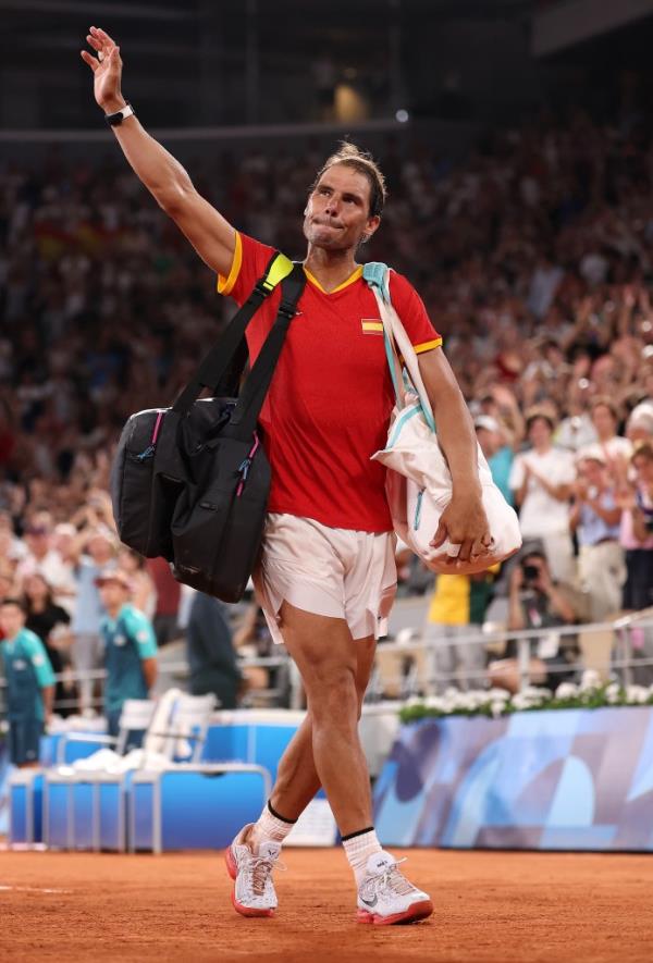 Rafael Nadal of Team Spain acknowledges the crowd as he leaves the court with partner (out of f<em></em>rame) Carlos Alcaraz of Team Spain after their Men's Doubles Quarter-final match against Austin Krajicek of Team United States and Rajeev Ram of Team United States on day five of the Olympic Games Paris 2024 at Roland Garros on July 31, 2024 in Paris, France.