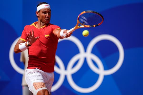 Rafael Nadal of Spain returns the ball against Marton Fucsovics of Hungary during the men's singles tennis competition, at the 2024 Summer Olympics, Sunday, July 28, 2024, in Paris, France.